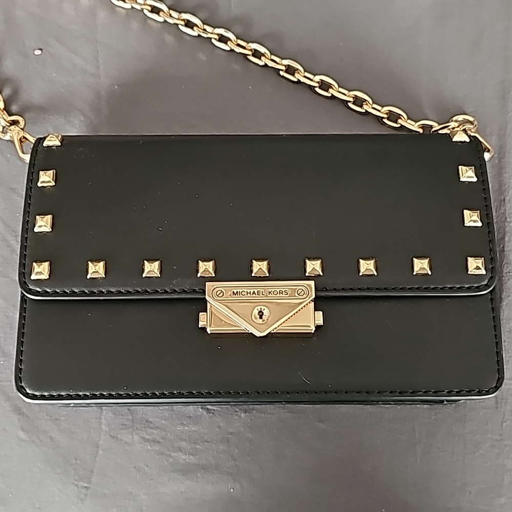 Michael Kors Black leather purse with gold hardware.